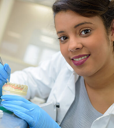 Dental lab technician prepping dental mold