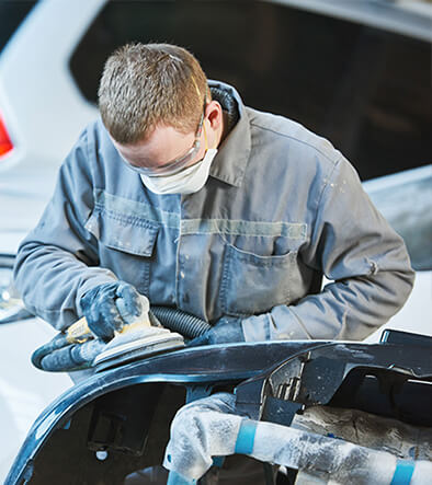 Automotive Collision Technology Technician buffing out a car