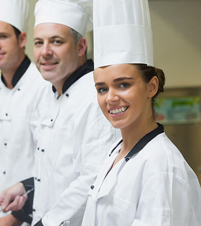 group of culinary chefs in kitchen