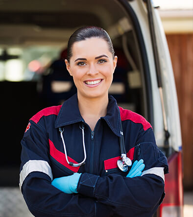 Emergency Medical Technician standing in back of an ambulance door