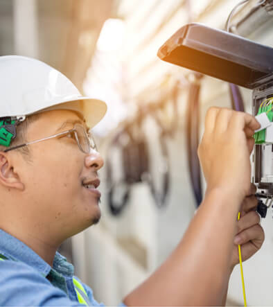 fiber optics technician working on cable box