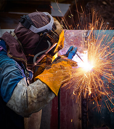 Welder technician with welding tool working on a project